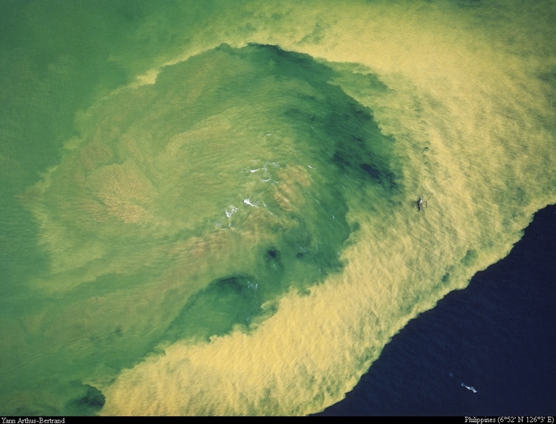 [B14 SLR: Yann Arthus-Bertrand] Gold mining wastes on Mindanao Island littoral; DISPLAY FULL IMAGE.